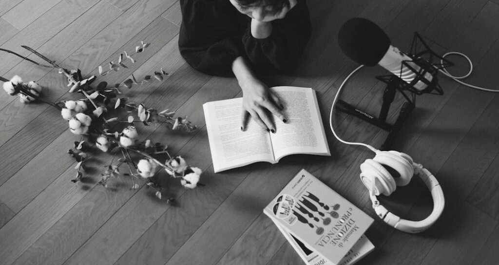 a person sitting on the floor reading a book